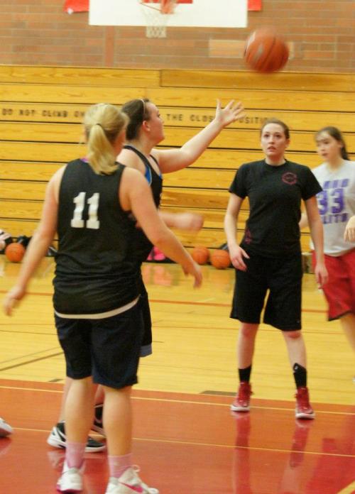 Hailey Hammer reaches out to snag a rebound during practice, as teammates Amanda Fabrizi (in black), Lauren Escalle and Madeline Strasburg (11) look on. (Shelli Trumbull photo)