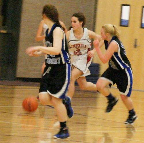 The action around her a blur, Wynter Thorne pushes the ball up-court for the Wolves. (Shelli Trumbull photo)