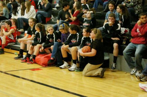 Members of the Wolf girls' JV hoops squad wait to take the floor. Utter destruction followed.