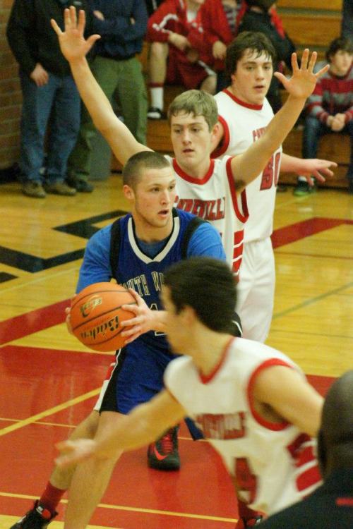 Aaron Curtin, backed up by Nick Streubel, applies intense defensive pressure.