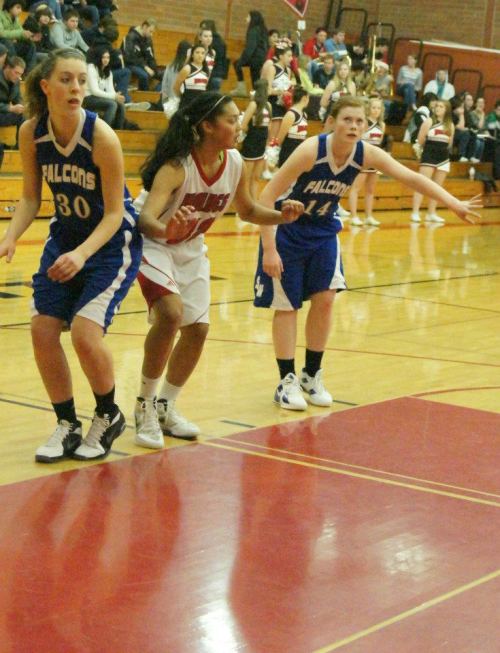 Makana Stone, center, prepares to launch in pursuit of a rebound.