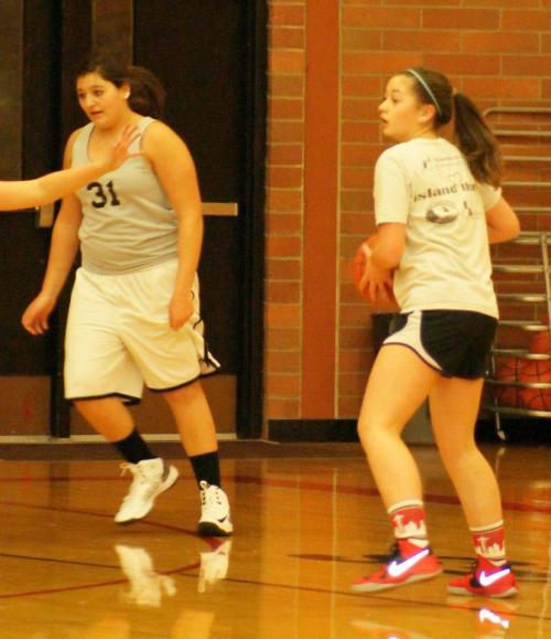 McKenzie Bailey (owner of the best socks in the game) prepares to bring the ball up during a recent practice, while Miranda Engle moves past her. (Shelli Trumbull photo) 