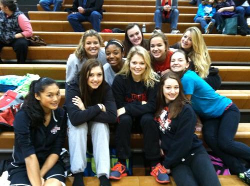 A healthy, happy Wolf girls' hoops squad celebrates its first win of the season. (Aimee Bishop photo)