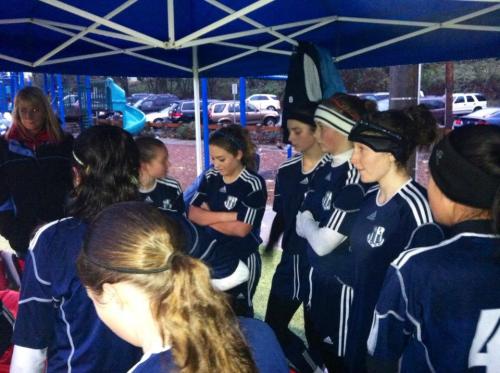 Players huddle under a tent before heading out into the cold rain. (Kali Barrio photos)