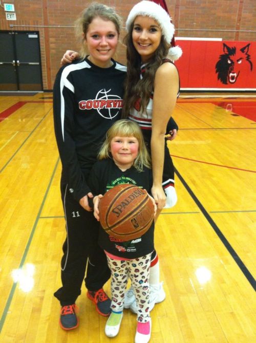 Breeanna Messner (left) in her post-game shoes, poses with Wolf cheerleader Iris Ryckaert and Messner's young cousin. (Aimee Bishop photo)
