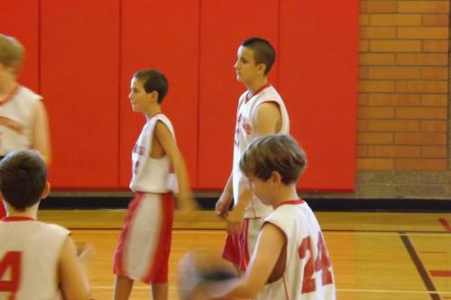 The Dennis Rodman of the 7th grade set -- Ethan "The Beast" Loy, pauses for a moment between teammates Nick Etzell (left) and JT Quinn (24).