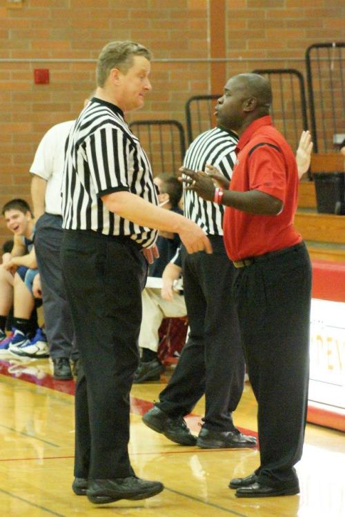 The ref who got run over by Caleb Valko -- who was scrambling to play defense -- then shoved Valko AND called a technical on him, talks to Wolf coach Anthony Smith. "Heh, heh, heh, coach, I'm just a big doofus..."