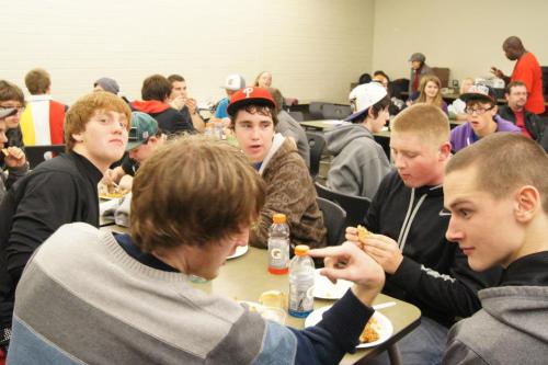 O'Keefe (far right) seems really, really interested in teammate Josh Wilsey's  finger during a team dinner.