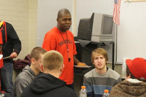 Having fought off the rampaging hordes, Wolf coach Anthony Smith tries to escape with a plate of food for himself.