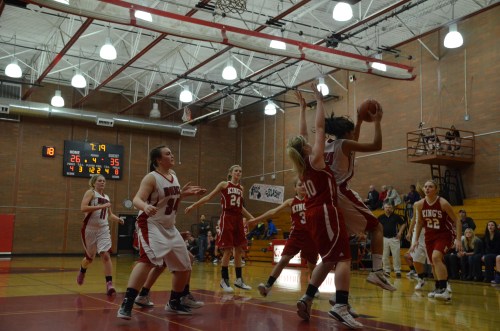 Makana Stone rips down a rebound under extreme duress. (Robert Bishop photos)