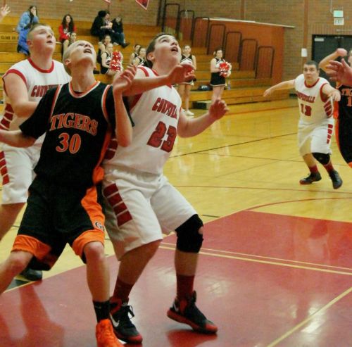 Aaron Trumbull (23) gets prime rebounding position, as teammate Carson Risner comes in for the backup. (Shelli Trumbull photo)