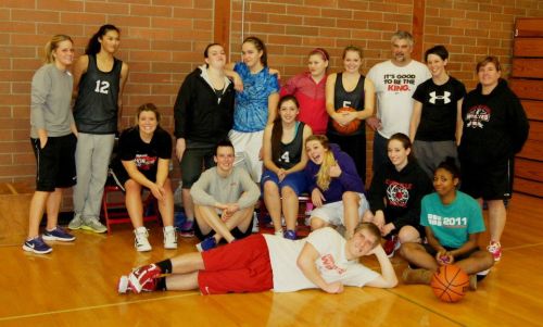 The varsity squad (minus Rhiannon Ellsworth), the coaching staff and visiting former great Erik King (in front) pose for a group photo after a scrimmage Thursday. (Shelli Trumbull photo)