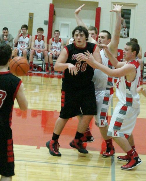 Facing a triple team, Nick Streubel makes the smart move and kicks the ball back out of the paint to a waiting shooter.