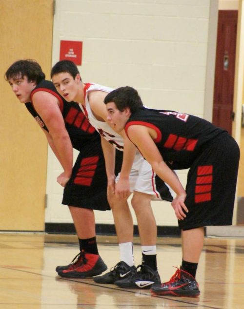 Ben Etzell (far right) and Nick Streubel prepare to squish an ATM player trapped between them.
