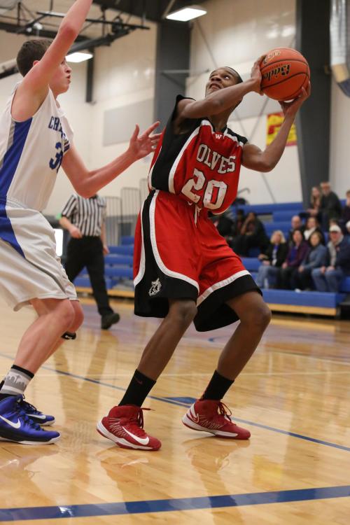 Anthony Bergeron takes the ball to the hoop under extreme duress.