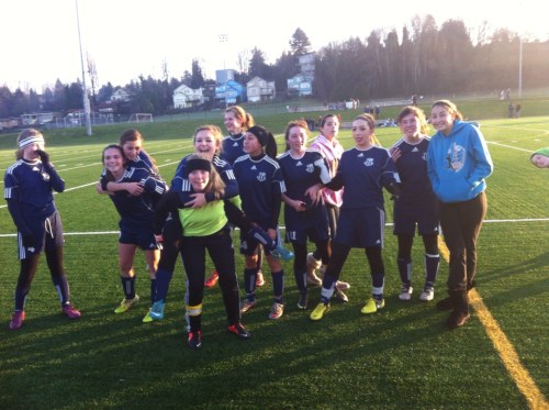 The GU17 squad celebrates, little realizing that #1 fan Ethan Spark (far right) is photo bombing them. (Kali Barrio photo)