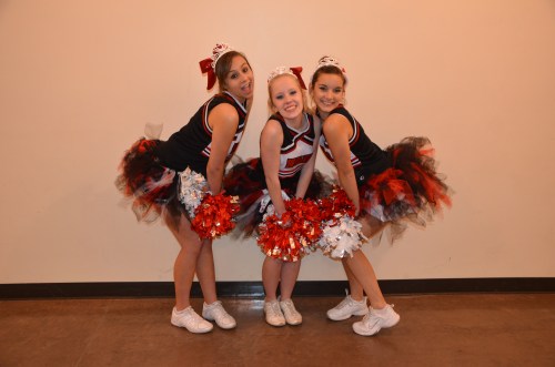 Senior cheerleaders (l to r) Nicole Becker, Emily Clay and Iris Ryckaert vamp for the camera. (Robert Bishop photo)