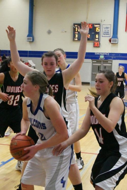 Hailey Hammer (hands raised) and Lauren Escalle apply pressure.