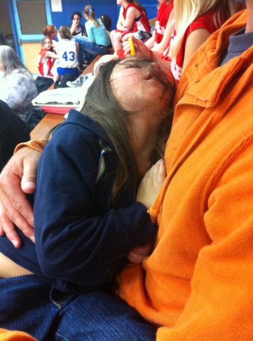 The excitement of seeing big sis Jae LeVine play middle school basketball was too much for Izzy LeVine Monday, so she promptly passed out. (Joline LeVine photo)
