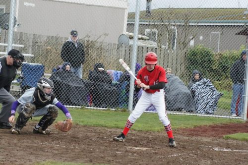 Baseball in March and the Nooksack Valley fans behind Bayne look less than thrilled with the weather.