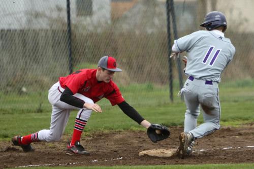 Aaron Curtin goes for the tag at third. The ump was wrong. The guy was out.