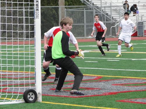 During JV action, Wolf goalie Connor McCormick guards the net.