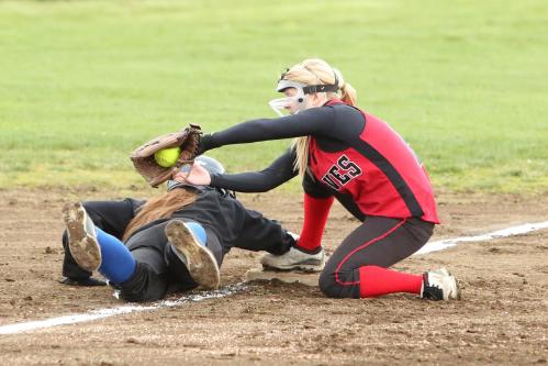 Madeline Roberts goes low to nail a runner coming in to third.