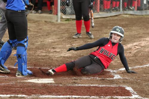 Madeline Roberts slides home with a run.