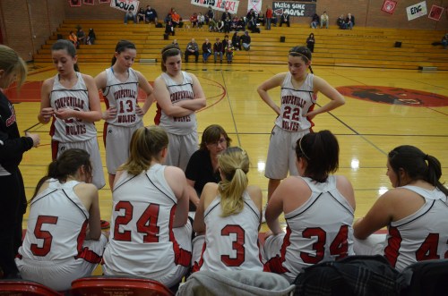 The Wolf JV girls' hoops squad listens to coach Amy King. (Robert Bishop photo)