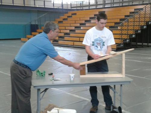 Sam Landau (right) fine-tunes his glider project.