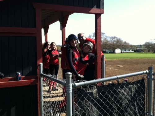 Softball coach David King photo-bombs his players. (Lisa Roberts-Edlin photo)