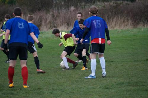 Sean Donley (yellow jersey) fights for the ball in a sea of blue. (Robert Pelant photos)