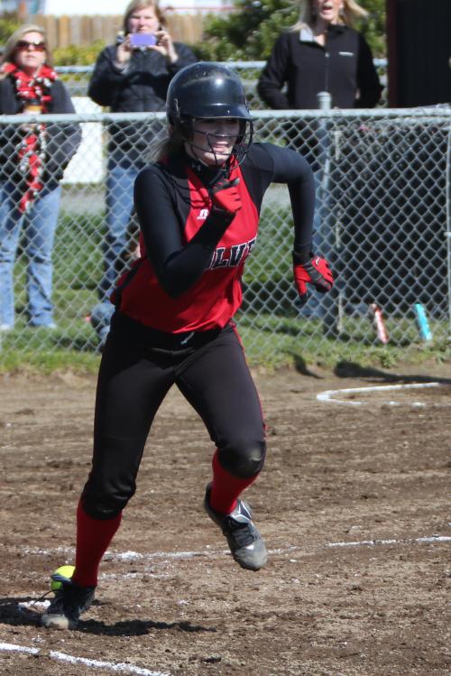 Breeanna Messner gets movin' as her beautiful one-inch bunt starts tunneling to China. (John Fisken photo)