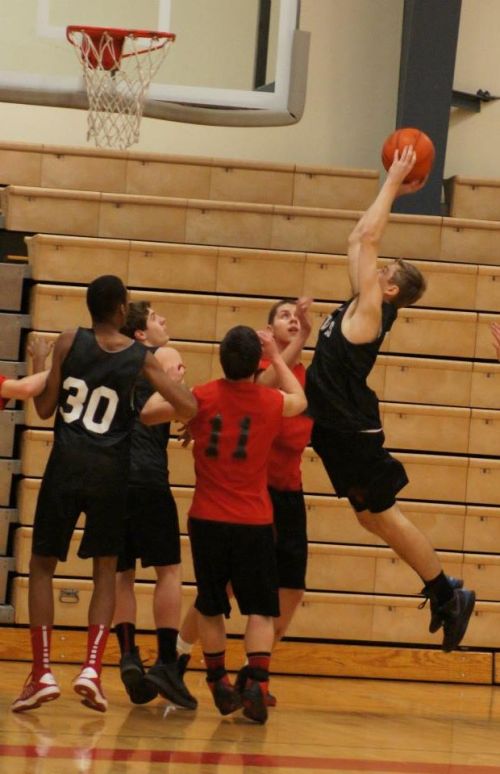 Curtin launches himself towards the hoop.