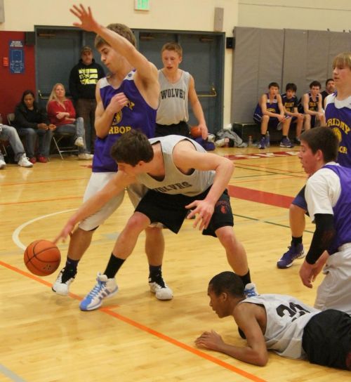 Hesselgrave tries to control the ball, while Bergeron (on floor) and Dalton Martin (behind) 