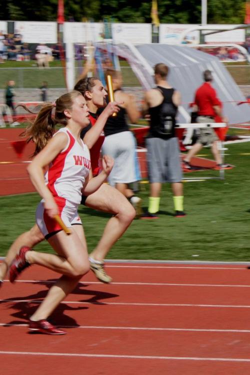 Anna Bailey (left) puts it into overdrive coming down the back stretch last season. (Shelli Trumbull photo)