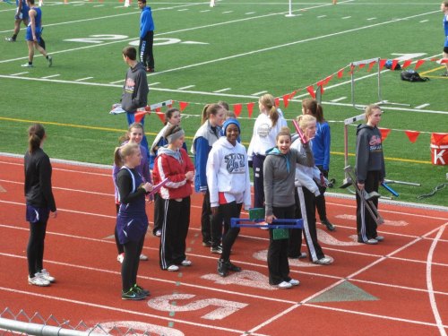 The 4 x 100 relay team awaits the start of their race. Left to right, 