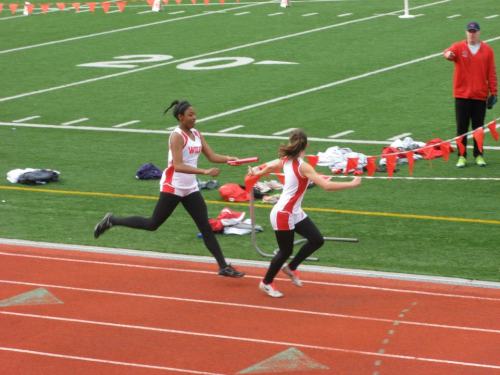 Jai'Lysa Hoskins (left) makes the baton hand-off to Sylvia Hurlburt during their run in the 4 x 200 relay. (Kristin Hurlburt photo)