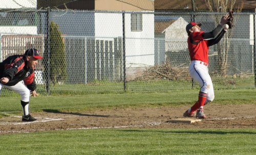 Morgan Payne tries to haul in a throw at third while the ATM coach screams for his man to hit the dirt.