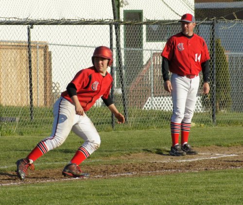 Drew Chan edges his way towards home, daring the catcher.