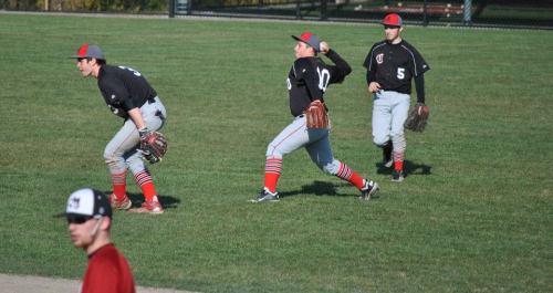 Kyle Bodamer prepares to unload a throw over Ben Etzell's head.