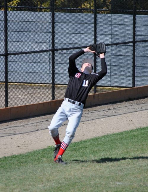 Aaron Curtin backpedals under a pop-up.