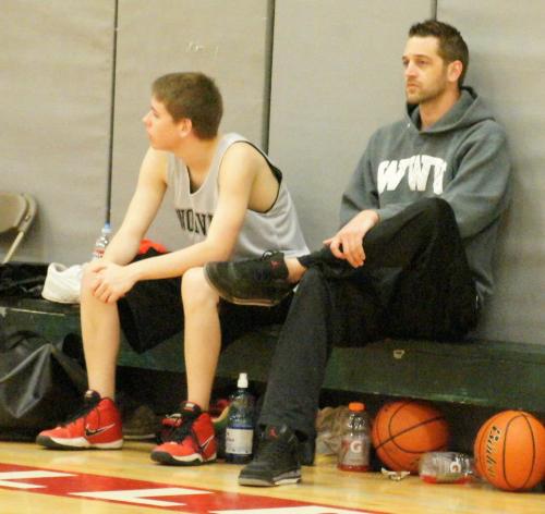 Isaac Vargas (left) and coach Scott Stuurmans ponder the game from the bench.