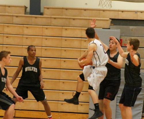 A Lakewood player runs into a wall of Wolves.