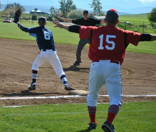 The ump takes a helpful hint from assistant coach Chris Tumblin.