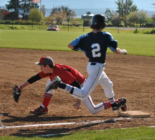 Aaron Trumbull makes the scoop at first.