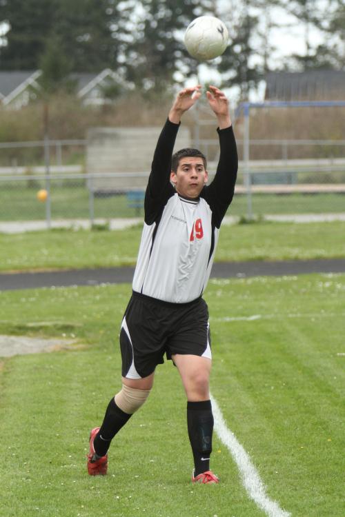 Team captain Oscar Liquidano makes a throw-in.