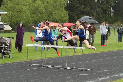 Madison Tisa McPhee, middle, blitzes the field in the hurdles.