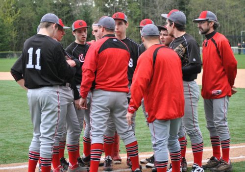 Wolf players and coaches listen to Willie Smith (second from left, in red). (Joan Payne photo)