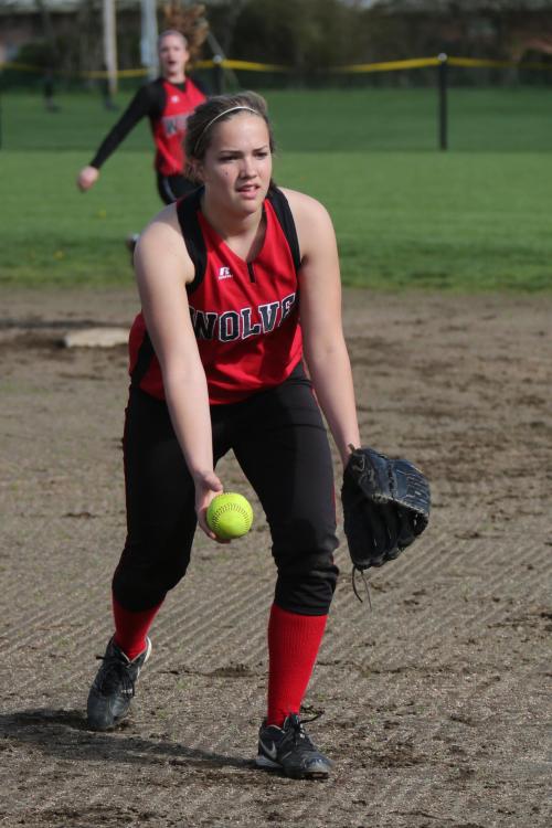 Having snagged the ball, first-baseman Bessie Walstad makes the throw to catch a runner.
